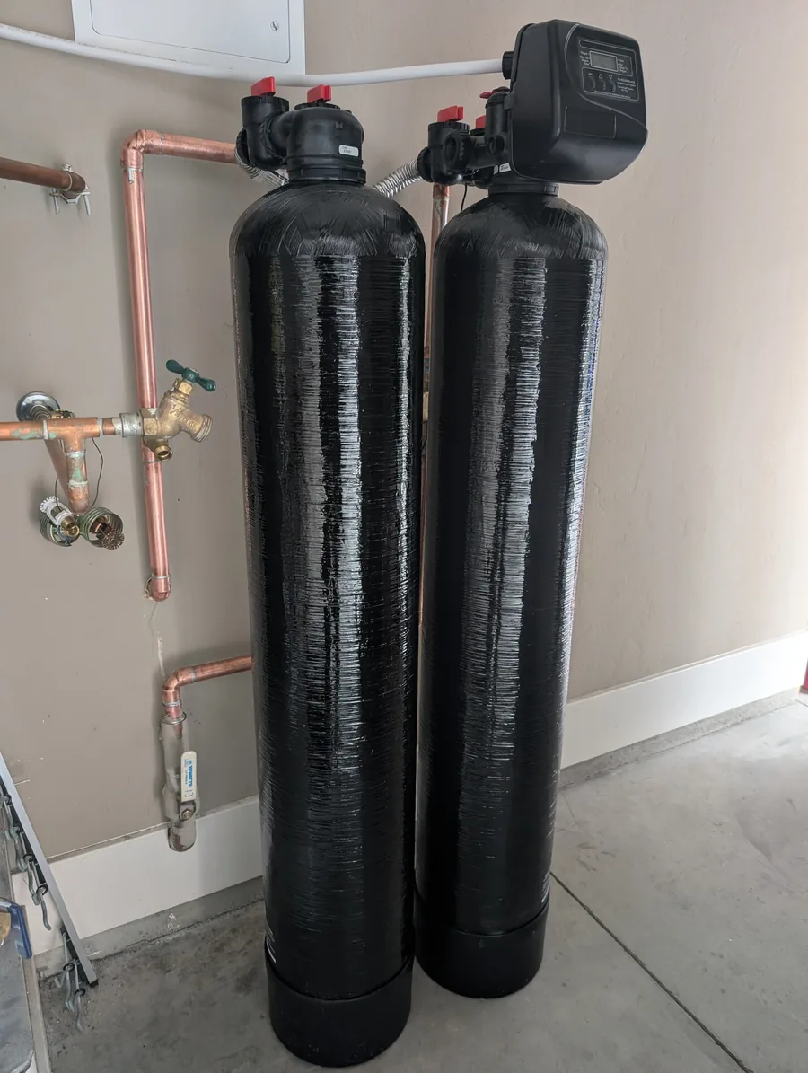 Two whole-house treatment tanks with copper piping and shutoff valves